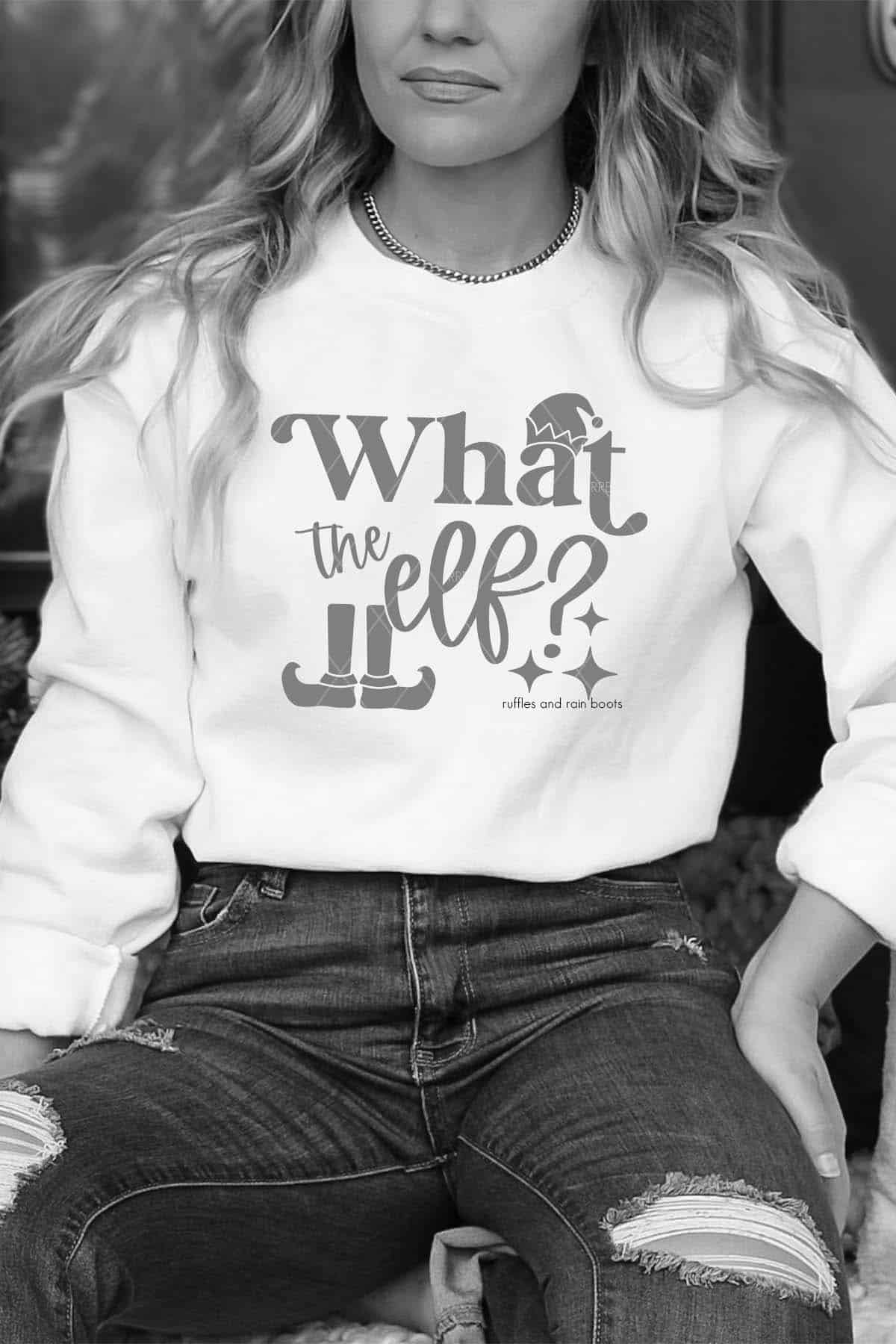 Vertical image of black and white image of woman in white sweatshirt which reads what the elf and text which reads free SVG.