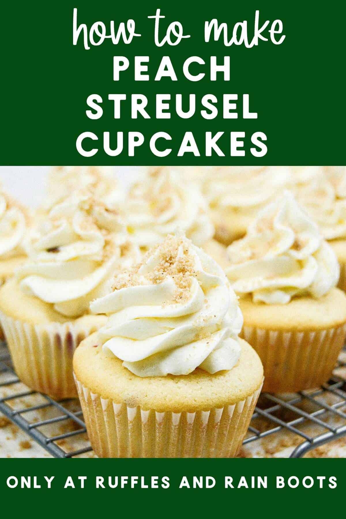 A metal cooling rack with a dozen peach streusel cupcakes on it with streusel scattered around against a white marble background.