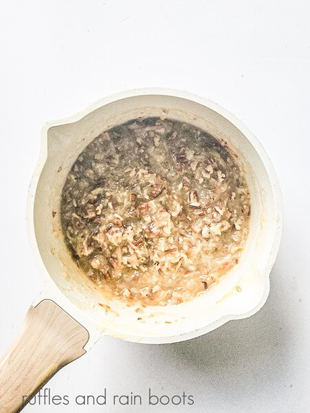 The topping for the German chocolate cupcakes mixed in a saucepan against a white surface.