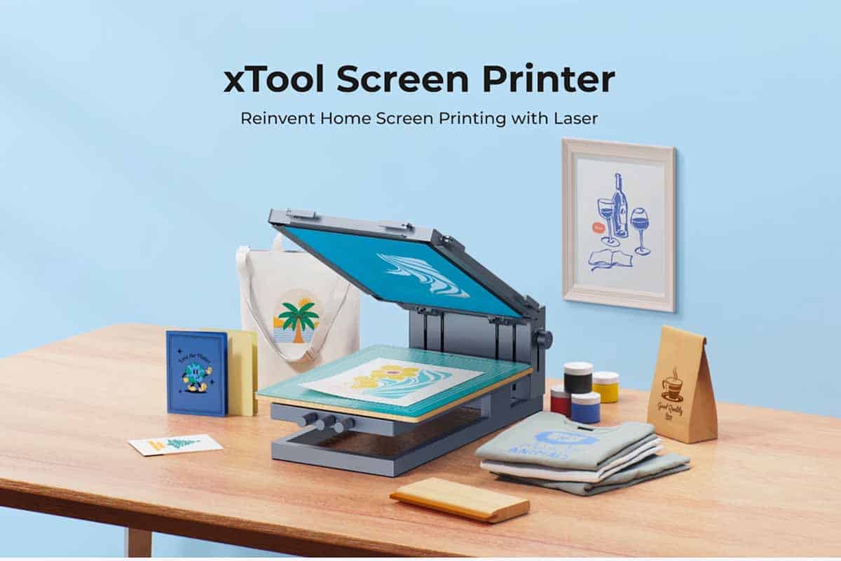 xTool Screen Printer Kickstarter promotional image of a screen printer, inks, and projects including totes, bags, t-shirts, cards, and wall art.