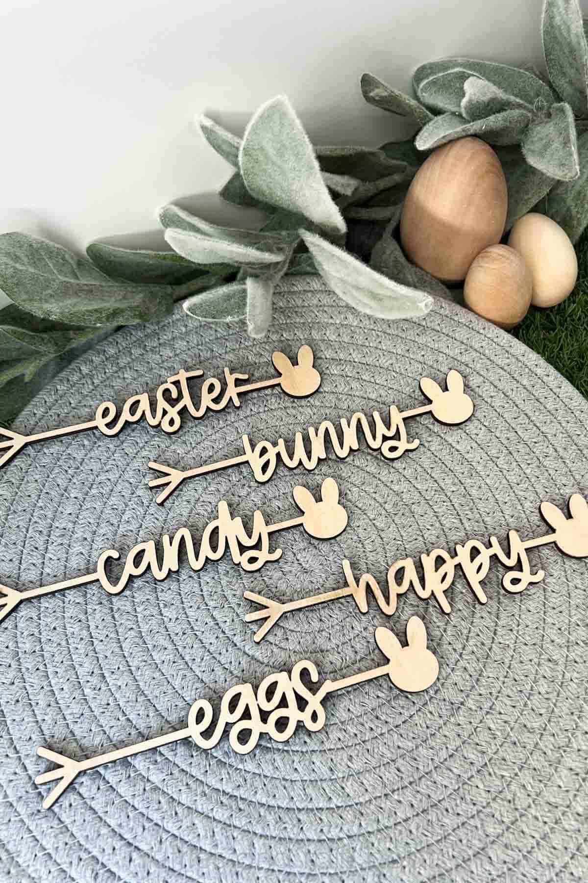 Vertical image of Easter plate names in wood cut with the laser ready SVG bundle of religious and Easter holiday plate words cut files.