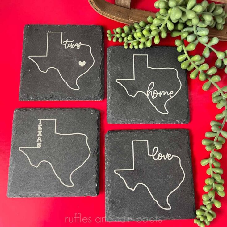 Vertical image close up of engraved slate coasters on a red background with a succulent accent.