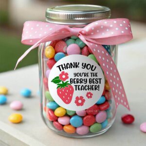 Square image of a berry best teacher free printable tag on the front of a candy jar with a pink bow.