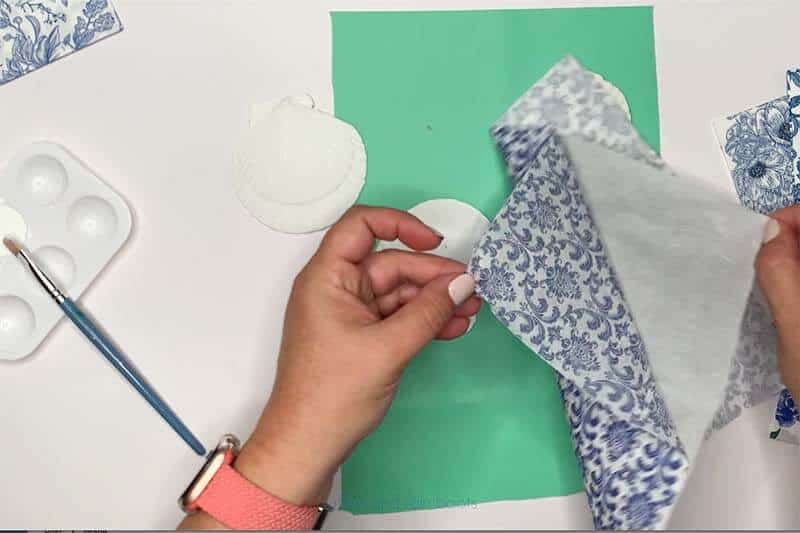 Crafter removing the ply layers from a decorative napkin.