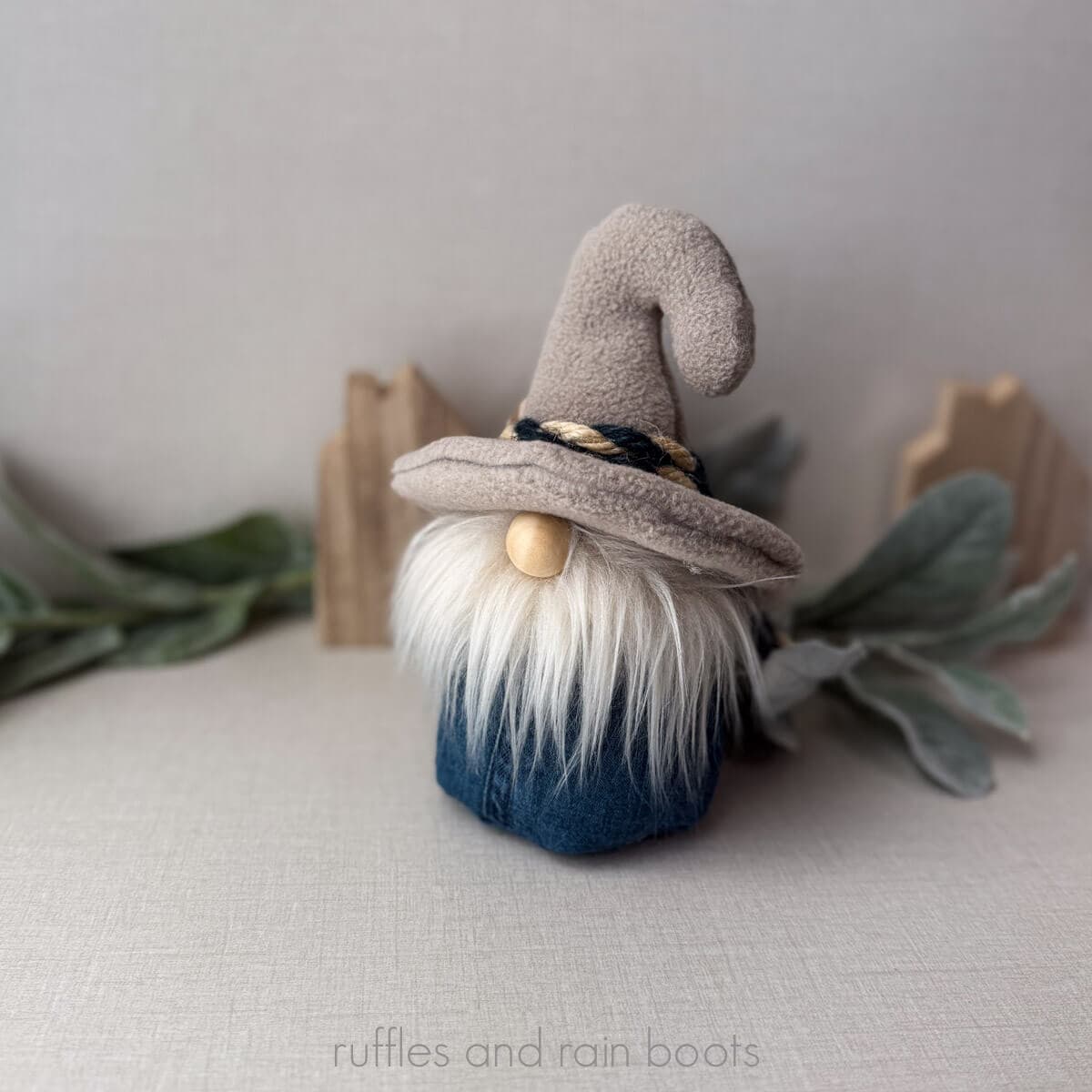Square image with a soft glow of a summer gnome made with dollar tree, rope, and denim.