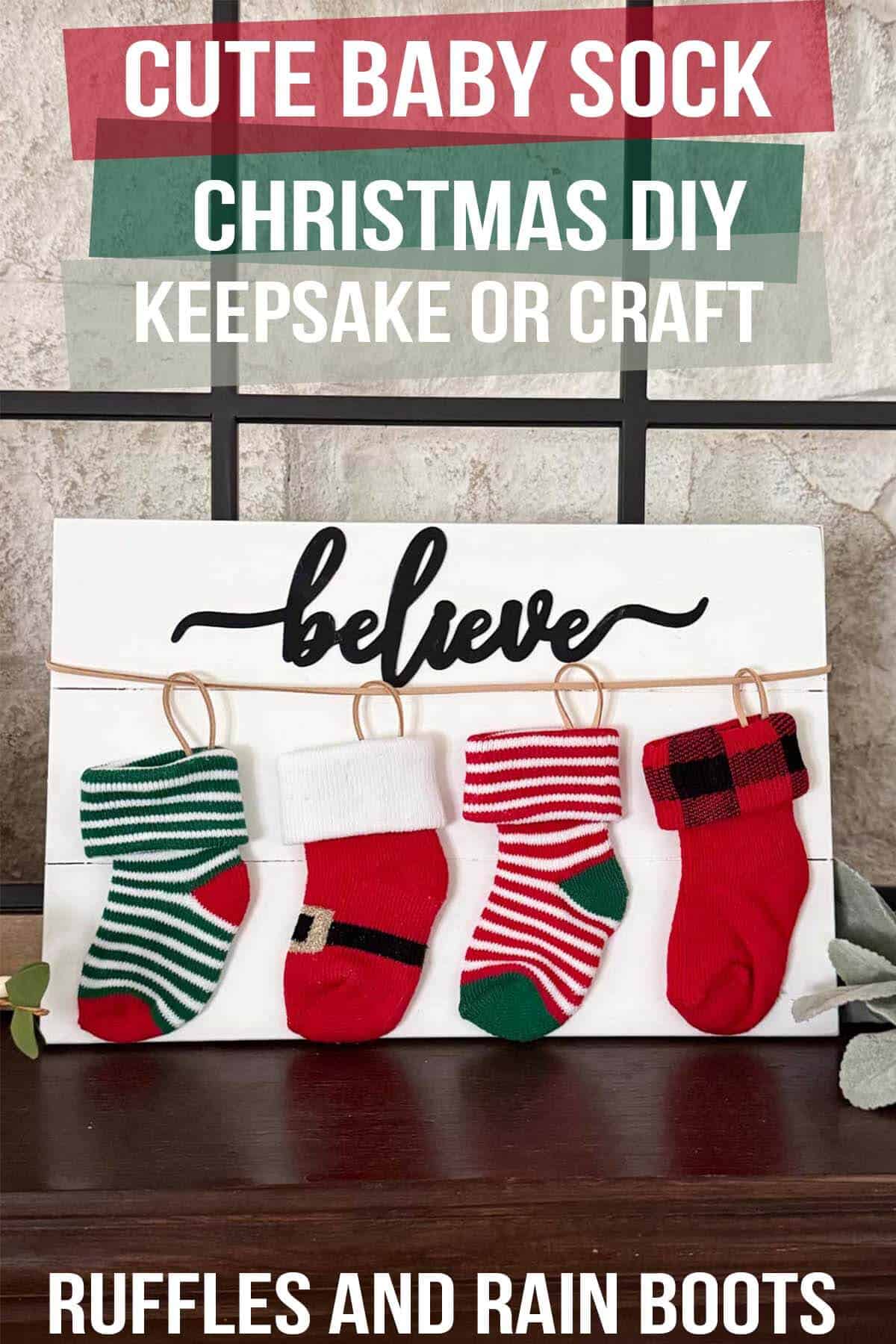 Vertical image of four baby socks on a wood plank with believe with text overlay which reads cute baby sock Christmas DIY keepsake or craft.