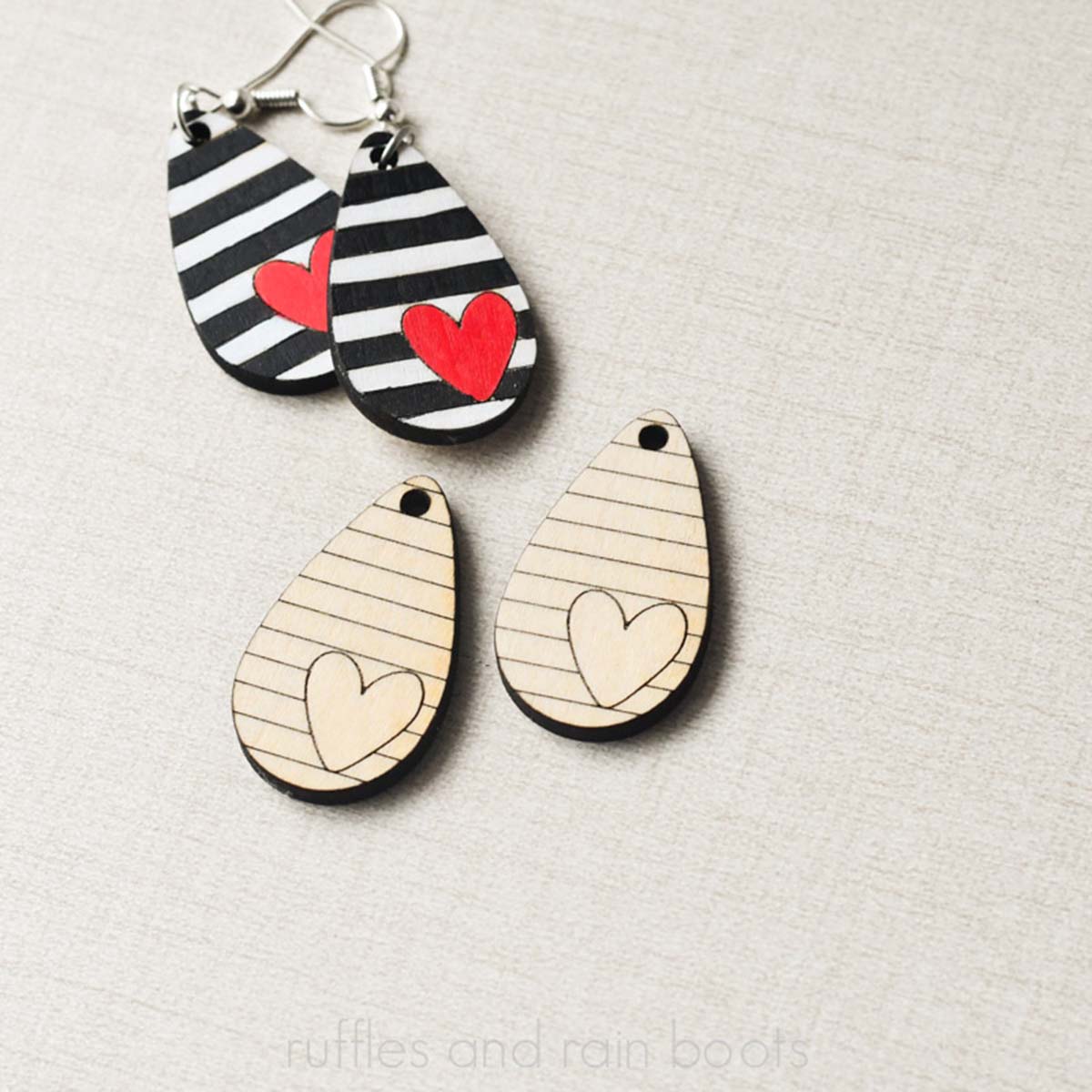 Close up square image of two pair of heart earrings made with the xTool M1 Ultra laser and basswood plywood.