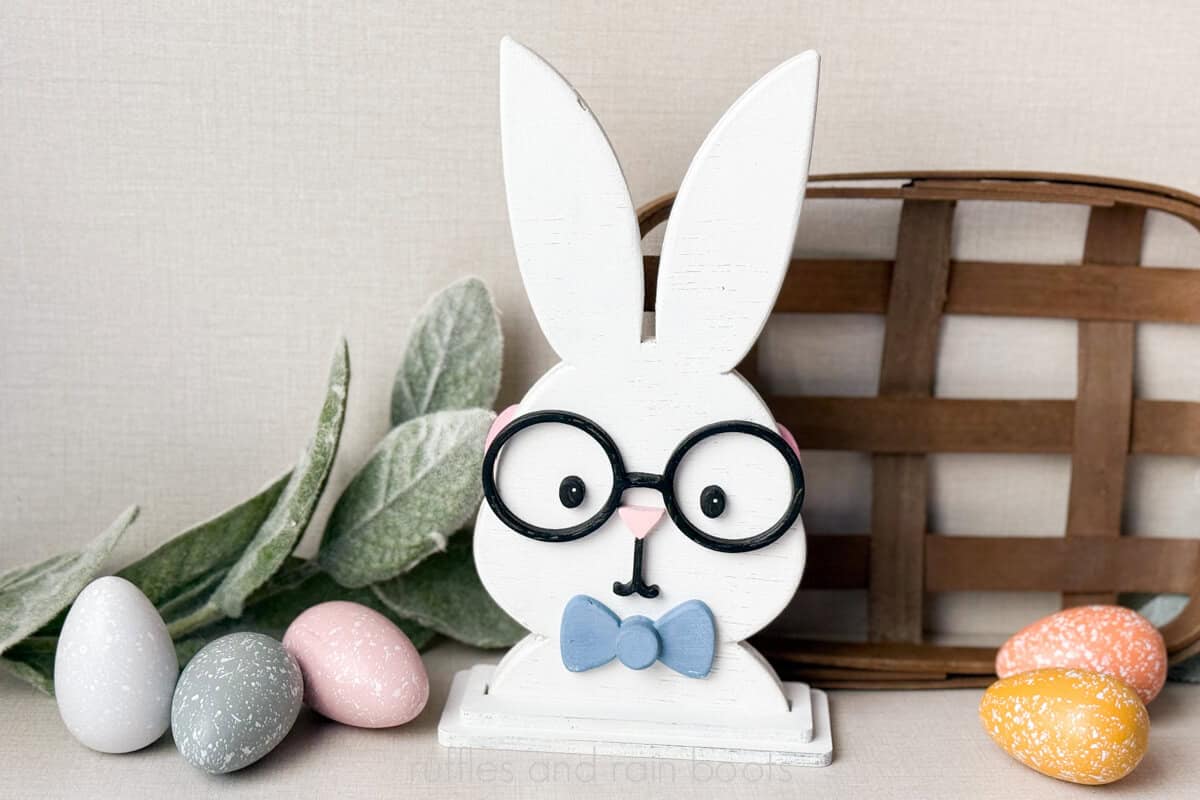 Horizontal image of a laser cut boy bunny with a bow tie shelf sitter on an Easter holiday background.