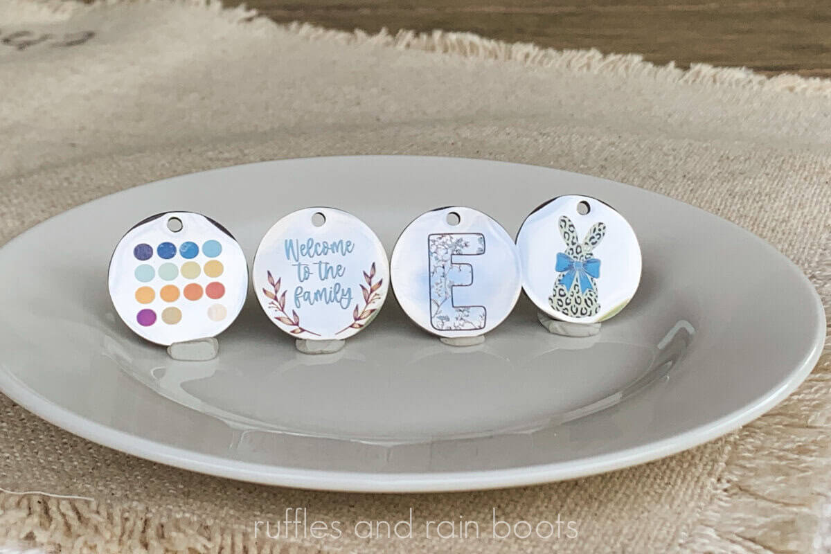 Horizontal image of four metal pendants engraved in color using the xTool F2; annealing in color.