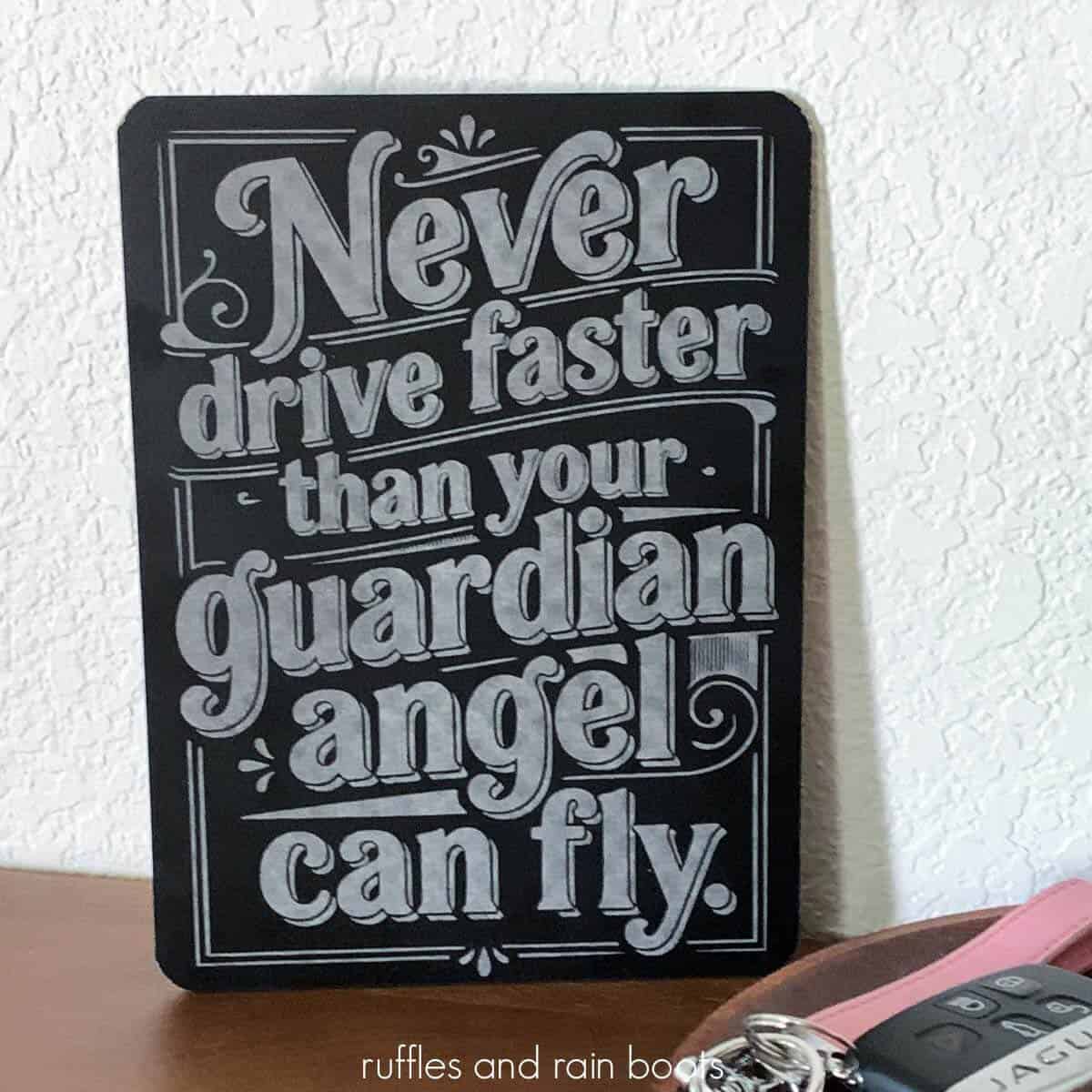 Close up square image of a dollar store chalkboard engraved with the xTool M2 laser which reads never drive faster than your guardian angel can fly in a vintage style.
